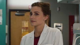 Lili Reinhart as Olive wearing a lab coat and looking forward in The Love Hypothesis. 