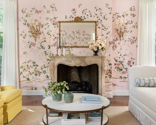 Pretty pink living room with floral wallpaper, decorated fireplace