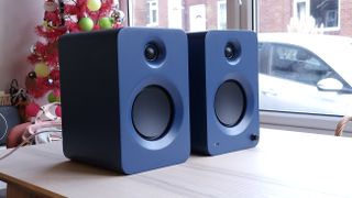 Kanto Ren speakers in blue, within a hi-fi listening room