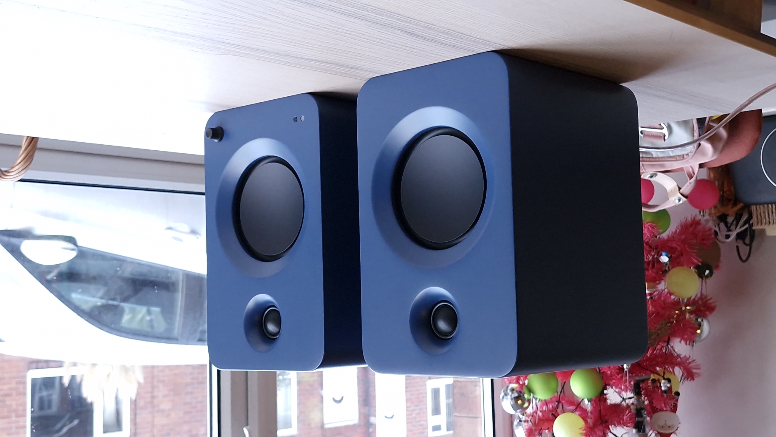 Kanto Ren speakers in blue, within a hi-fi listening room