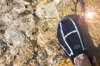 what are water shoes: foot in water