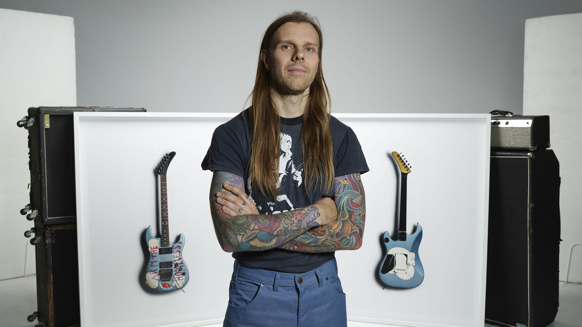 Kane Hibberd with images of Tom Morello’s Arm The Homeless guitar