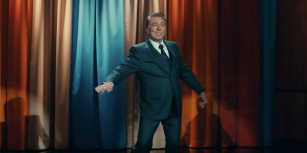 Joker Robert DeNiro hams it up in front of the late night curtain