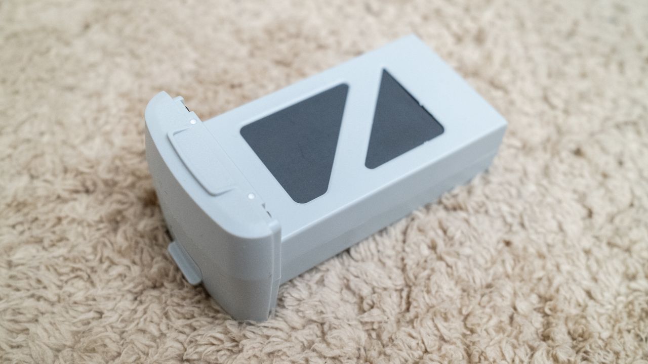 Holy Stone HS360E drone battery on a beige carpet