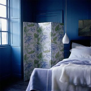 bedroom with navy blue walls and window