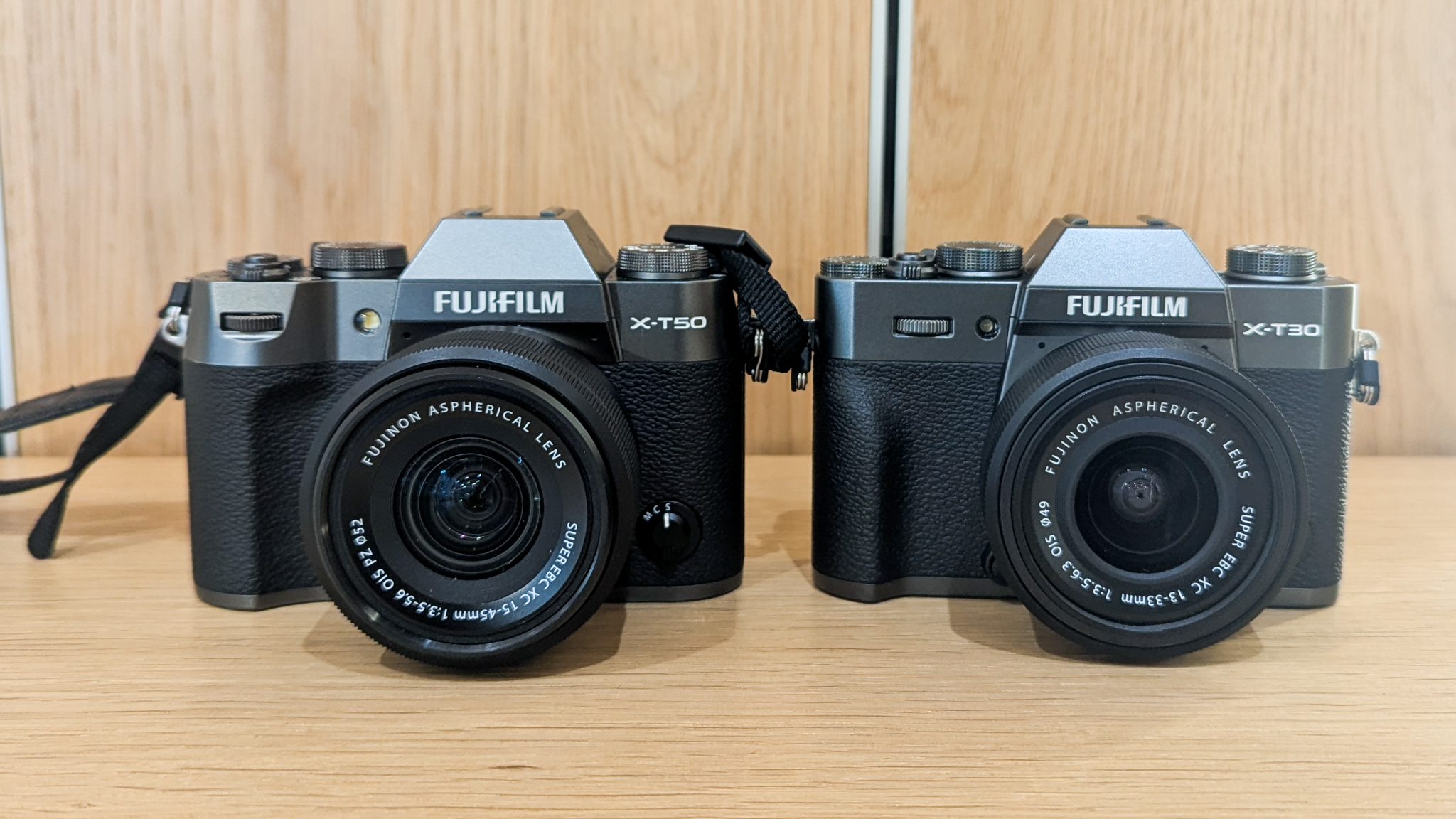 A Fujifilm X-T50 next to a Fujifilm X-T30 III