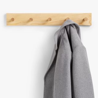 wooden 5 peg coat hook with grey coat on hook