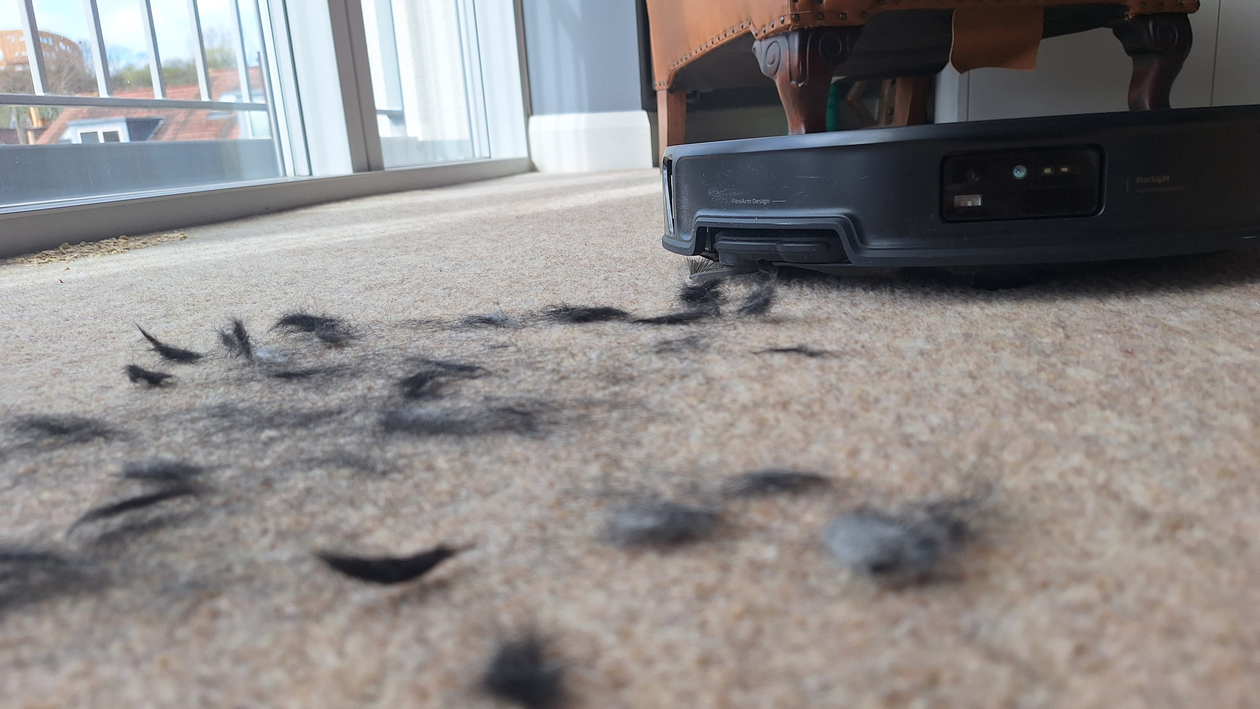 Roborock Saros 20 clearing pet hair from a carpeted floor