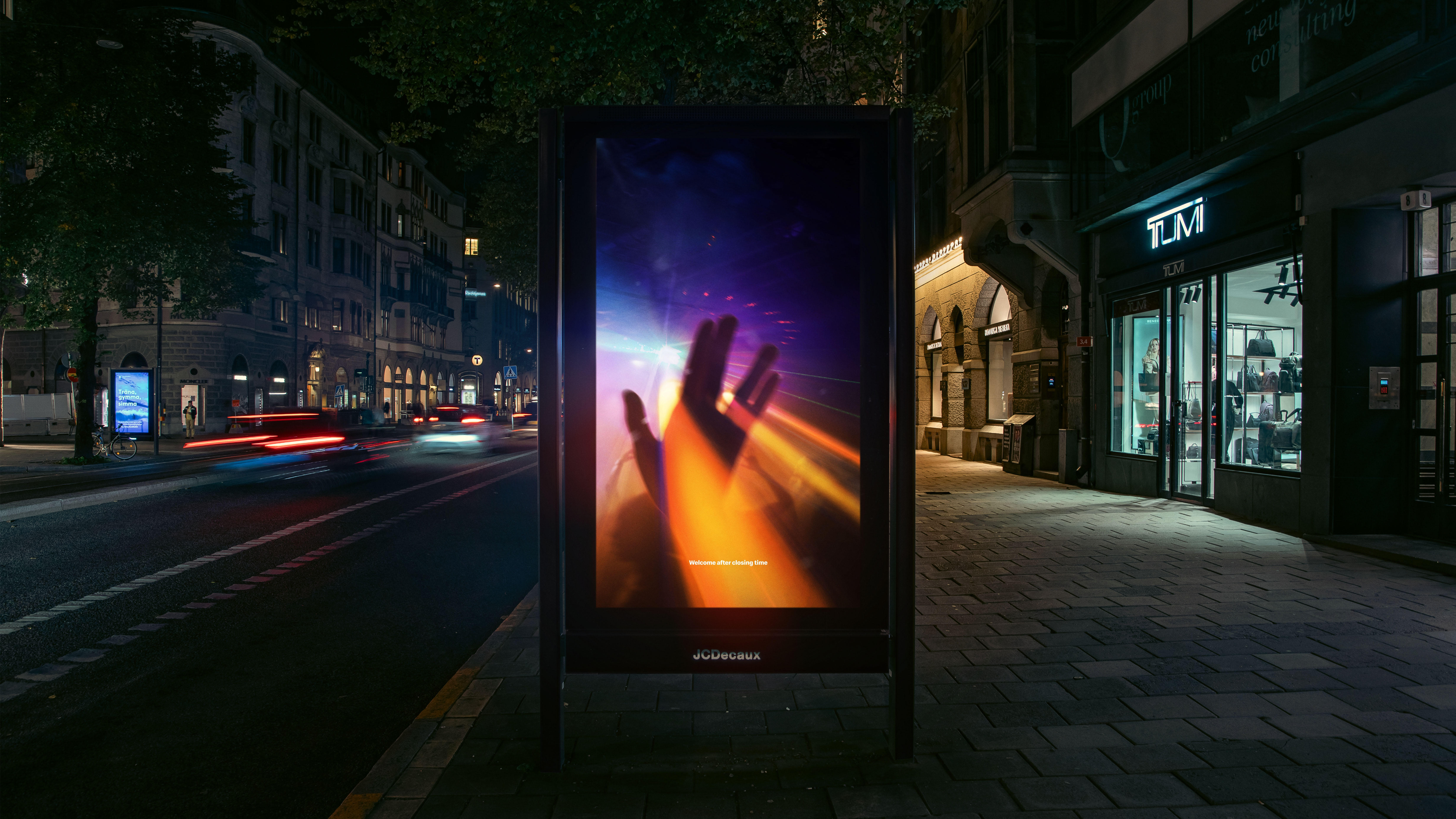 An image of a poster on a bus shelter showing a McDonald's advert featuring an optical illusion in which the Mcdonald's logo looks like lights shining on the floor in a nightclub