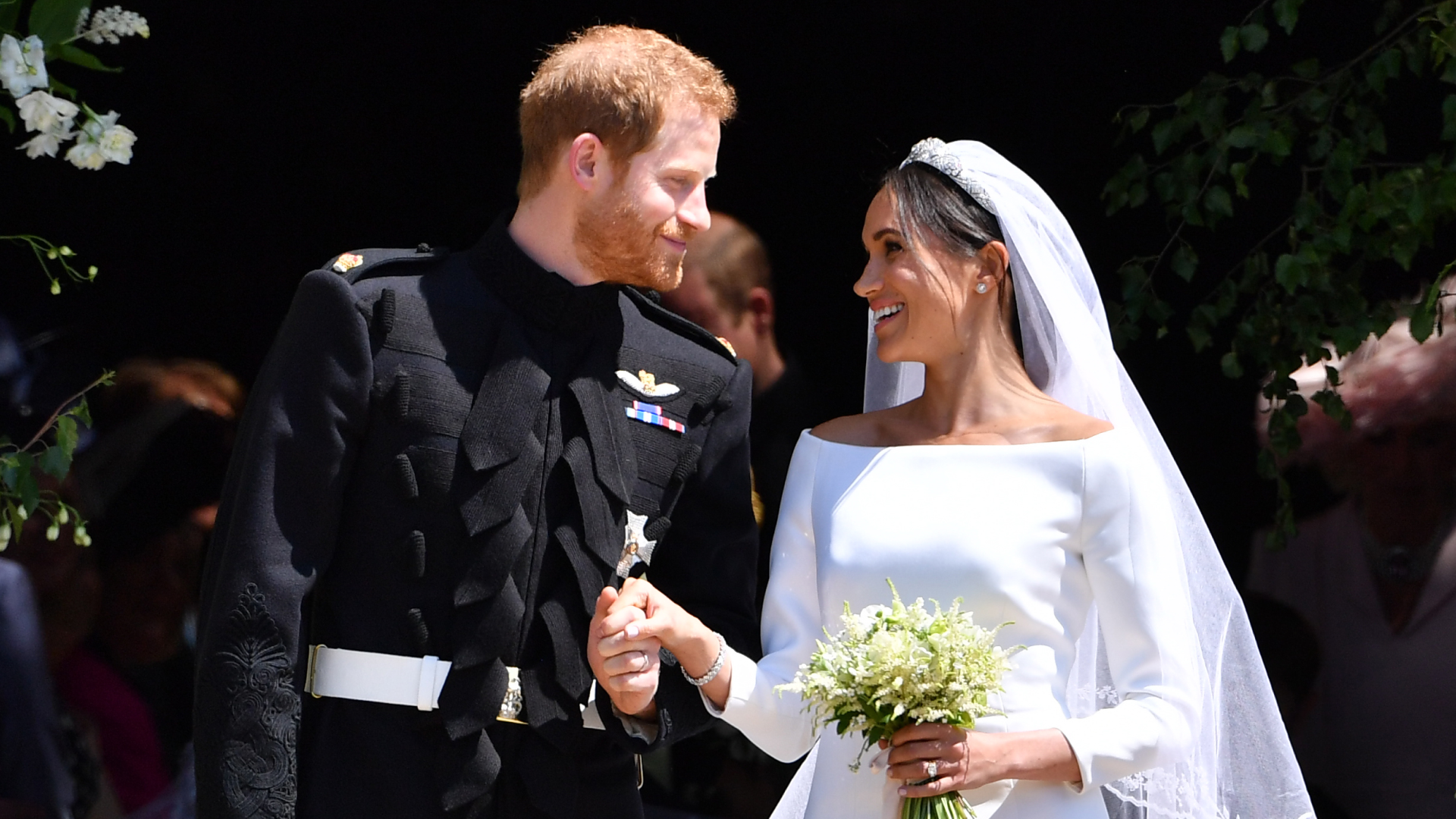 Prince Harry and Meghan Markle on their wedding day smiling at each other