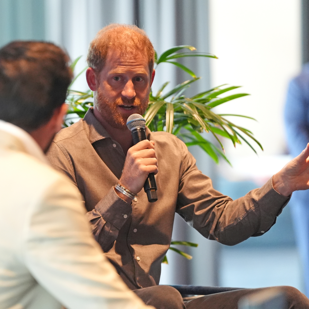 Prince Harry speaking into a microphone 