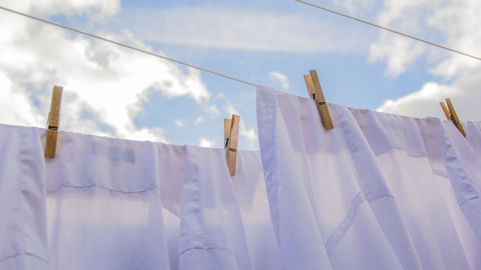 Fresh Clean Clothes Are Drying Outside. Clothes Hanging To Dry On