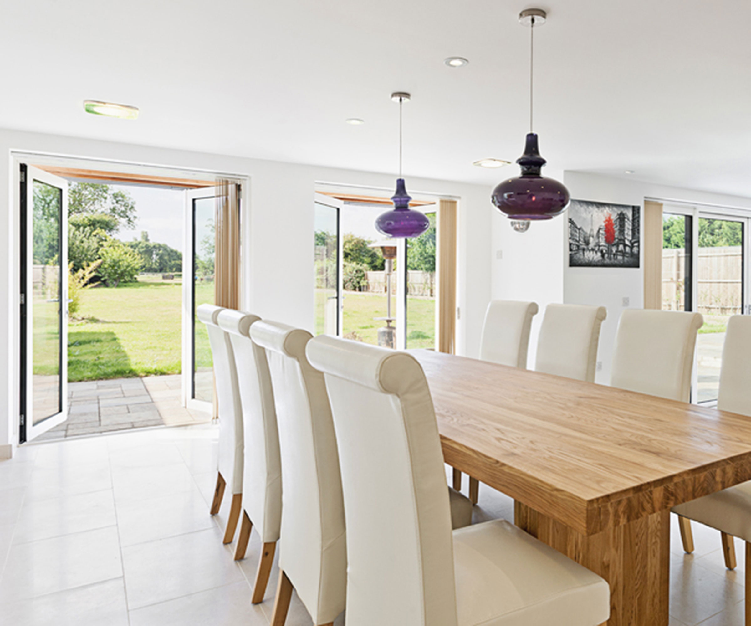 modern dining room with modern French doors opening out to patio