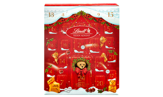 A red christmas calendar with a brown teddy bear in the middle.