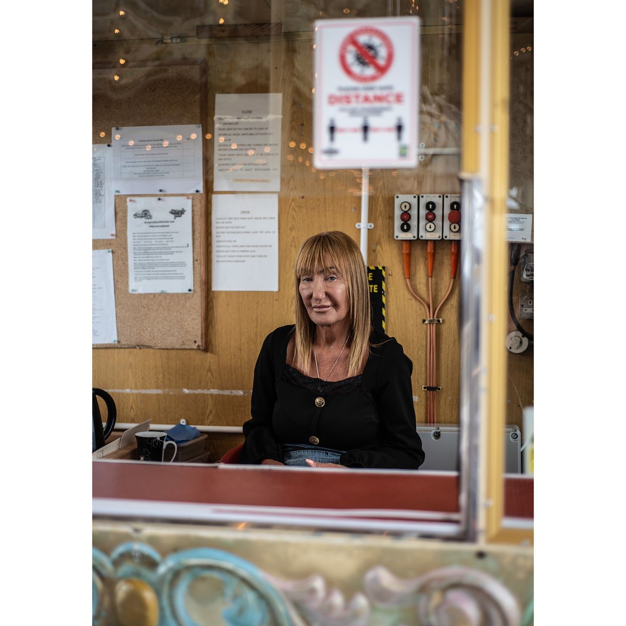 Discover interesting people and use your 50mm lens with an f/2 aperture. This is Ann Chesters, ride operator on the North Pier