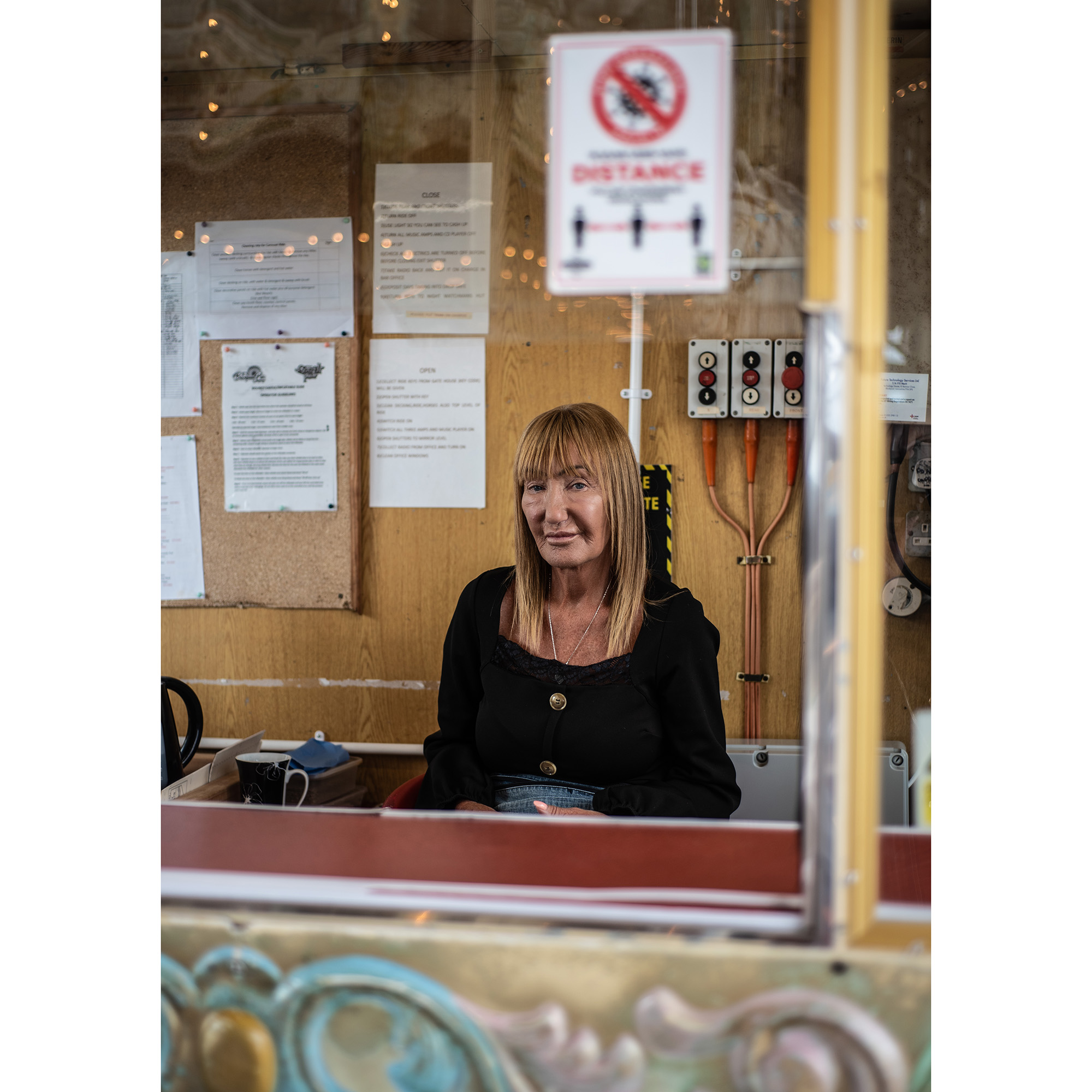 Discover interesting people and use your 50mm lens with an f/2 aperture. This is Ann Chesters, ride operator on the North Pier