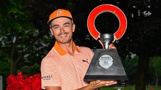 Rickie Fowler with the trophy after winning the Rocket Mortgage Classic