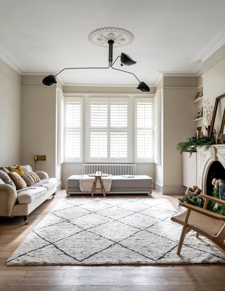 white living room with berber rug and shutters