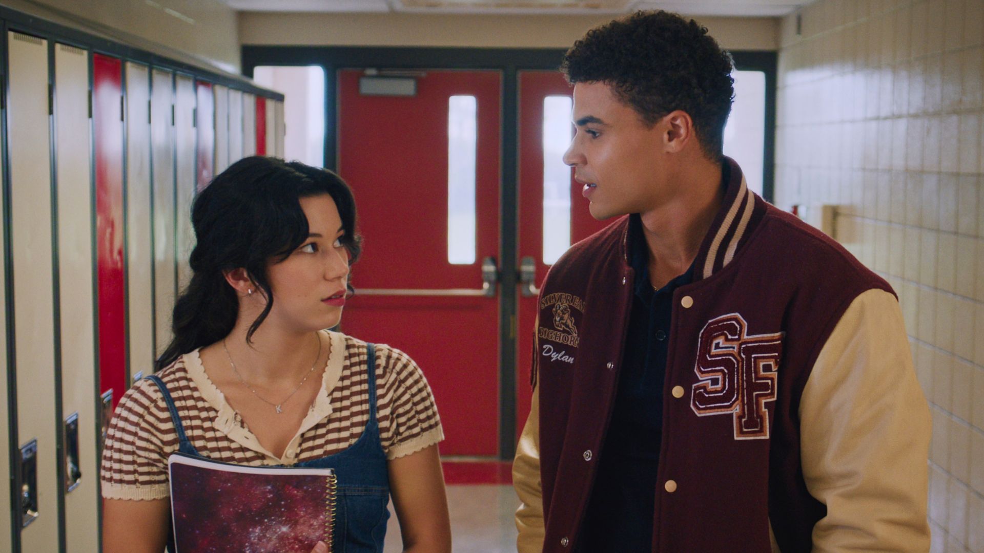 Kiley and Dylan talk while walking through the school halls