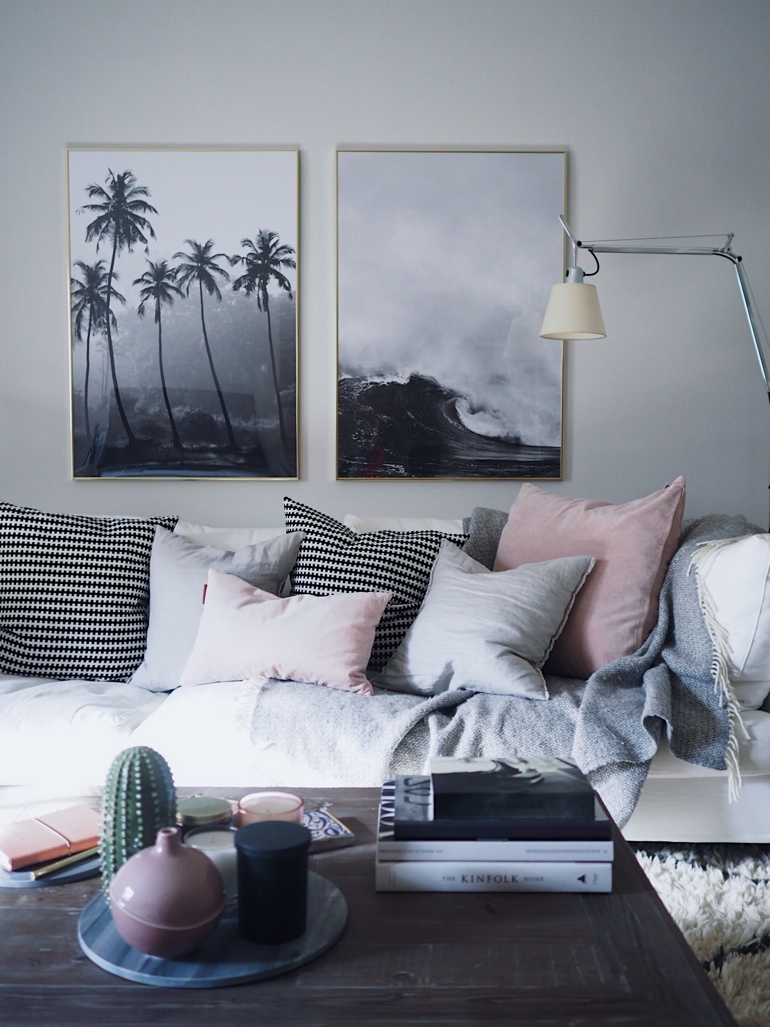 Pink and grey living room with black and white prints