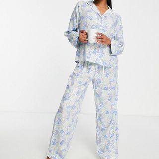 model wearing asos design white and blue ditsy print pajama set