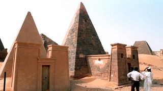 Visitors look at the pyramids of the Sudanese kingdom of Meroe 08 March in Sudan.