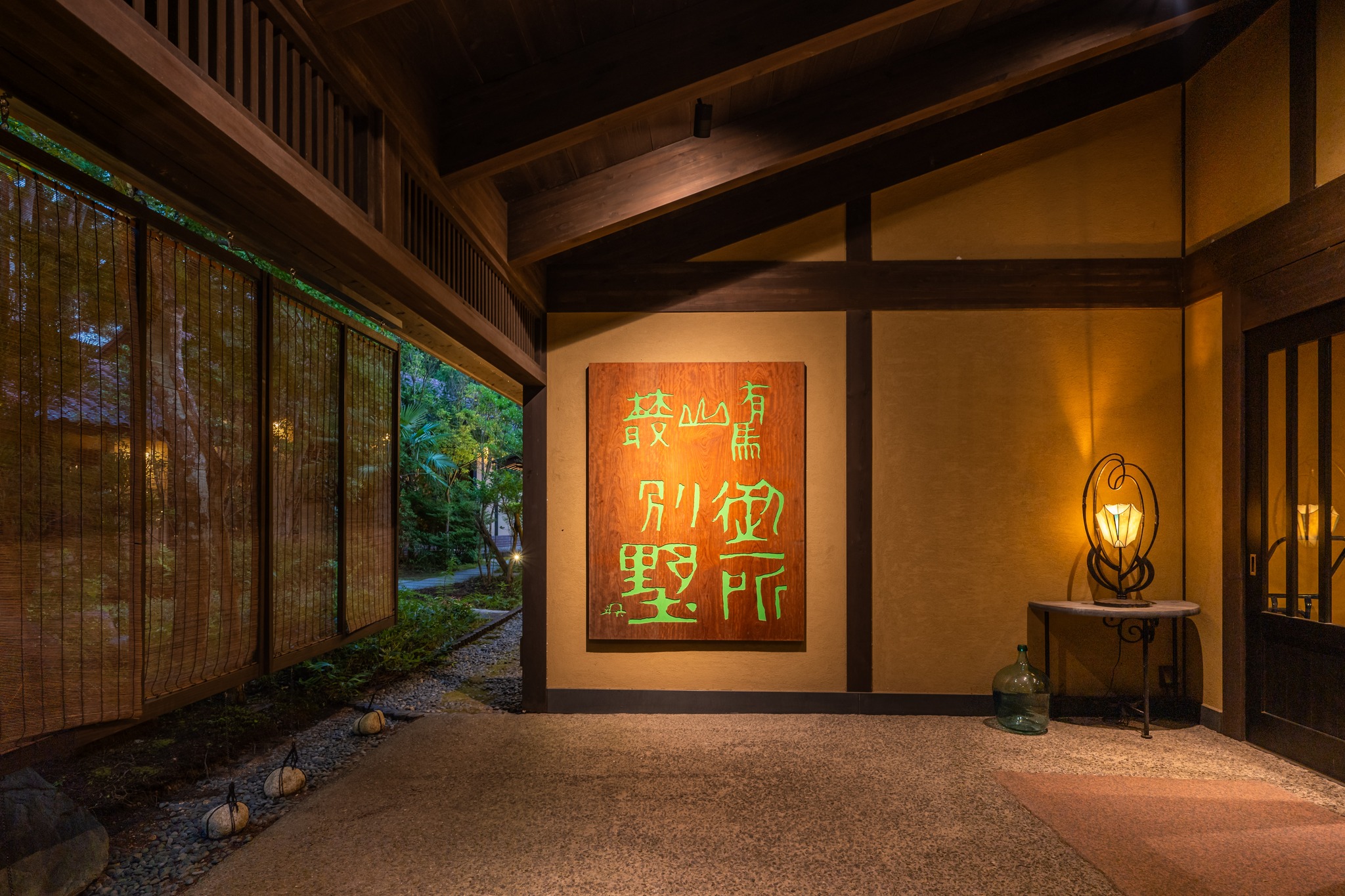A luxury Japanese hotel boasting warmly lit interiors and traditional decor while being totally immersed in nature.