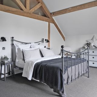 grey and white neutral bedroom with wooden beams