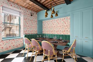 modern kitchen with floral wallpaper and banquette seating