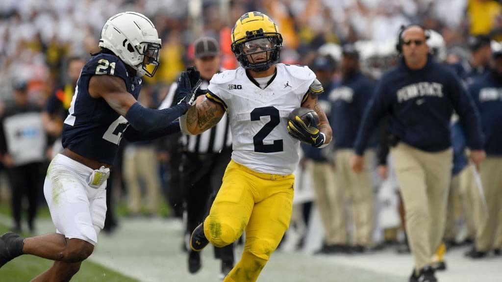 Michigan running back Blake Corum (2) is pushed out of bounds at the end of a long first half run by Penn State safety Kevin Winston, Jr. (21) as Penn State head coach James Franklin watches during the Michigan Wolverines versus Penn State Nittany Lions game on November 11, 2023 at Beaver Stadium in University Park, PA.