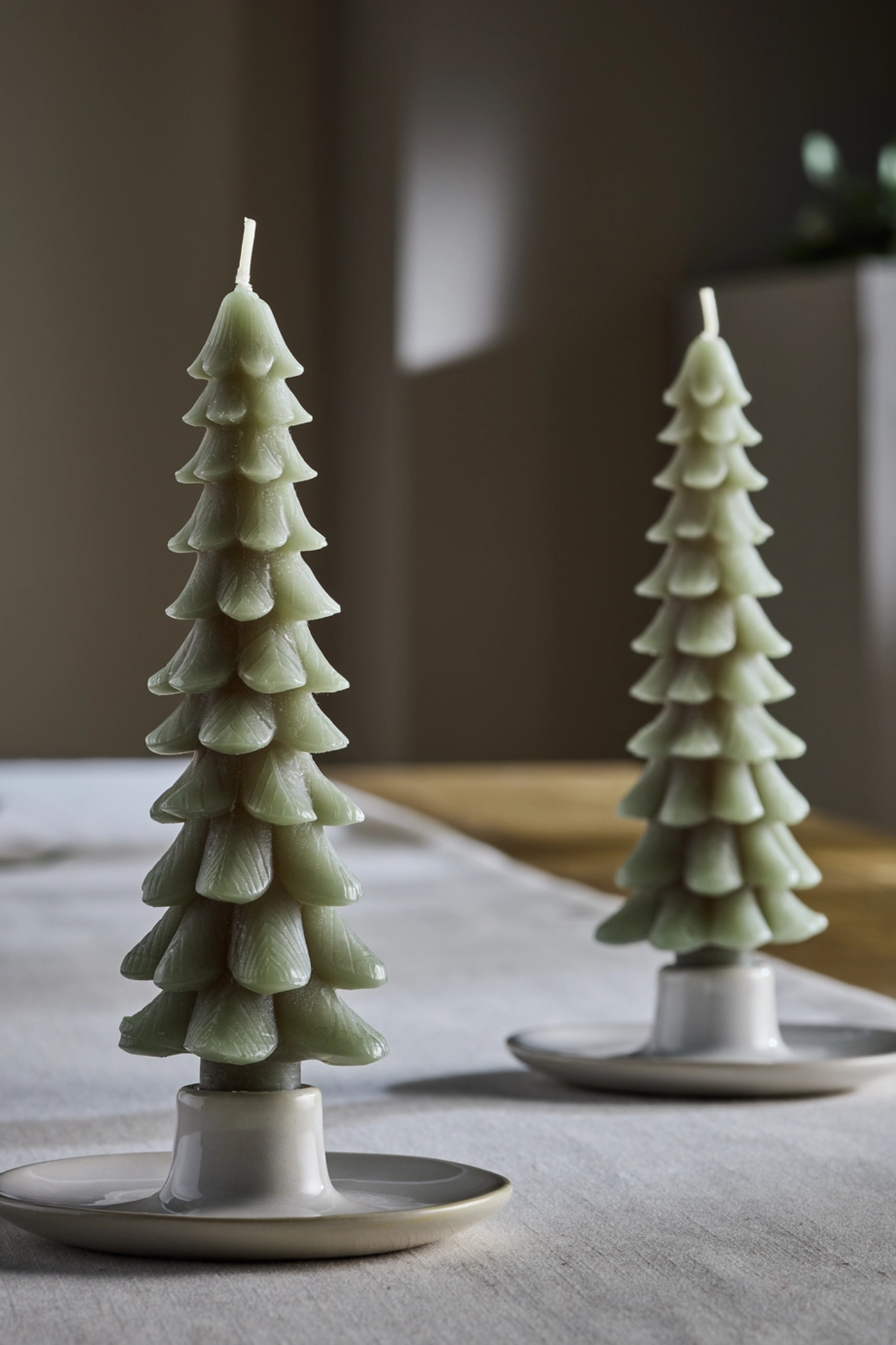 A set of two green Christmas tree shaped taper candles