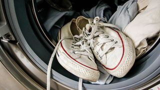 Sneakers in the washing machine stock image