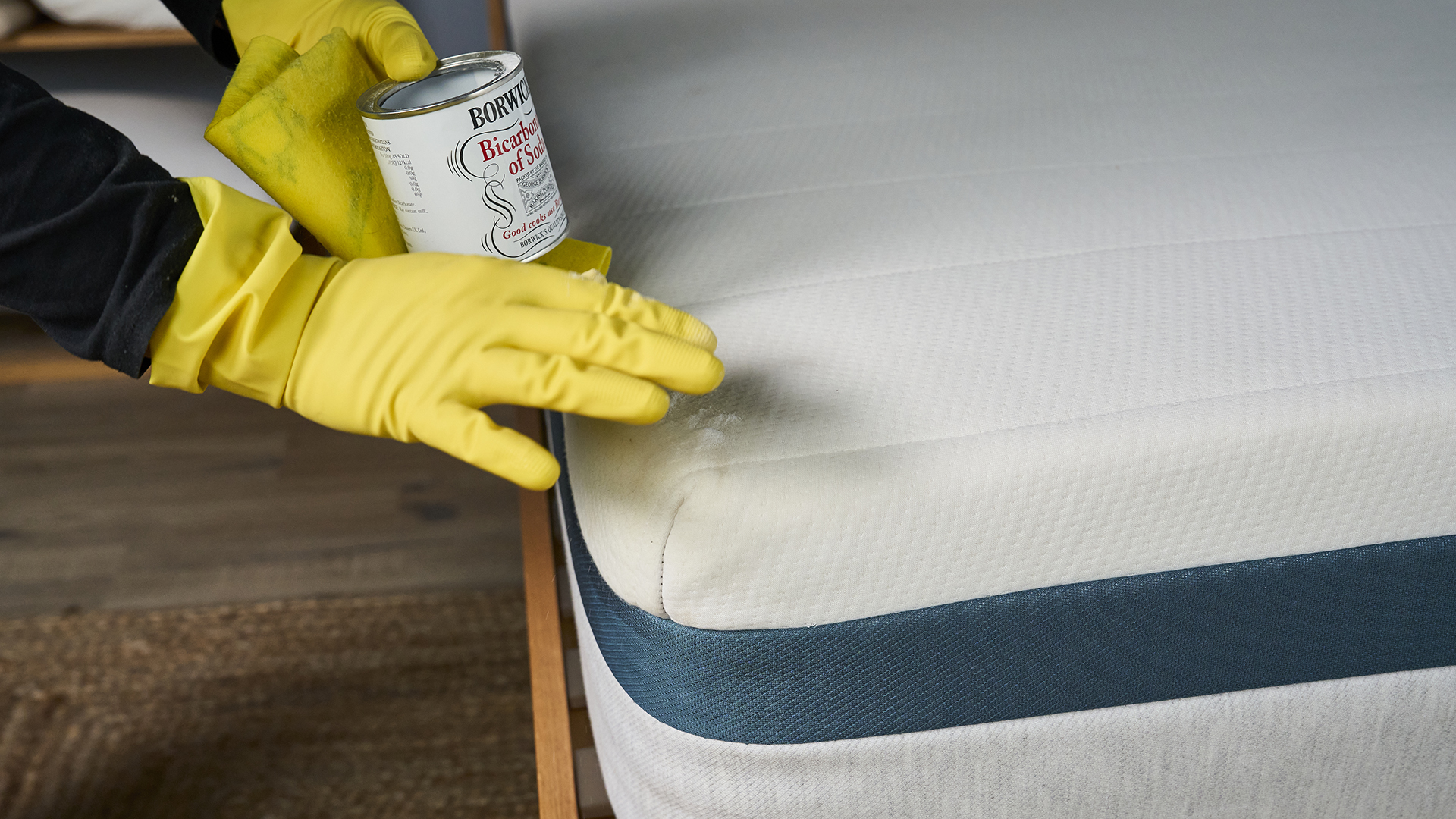 The Tom&#039;s Guide Sleep Team using baking soda to clean a stain from a mattress