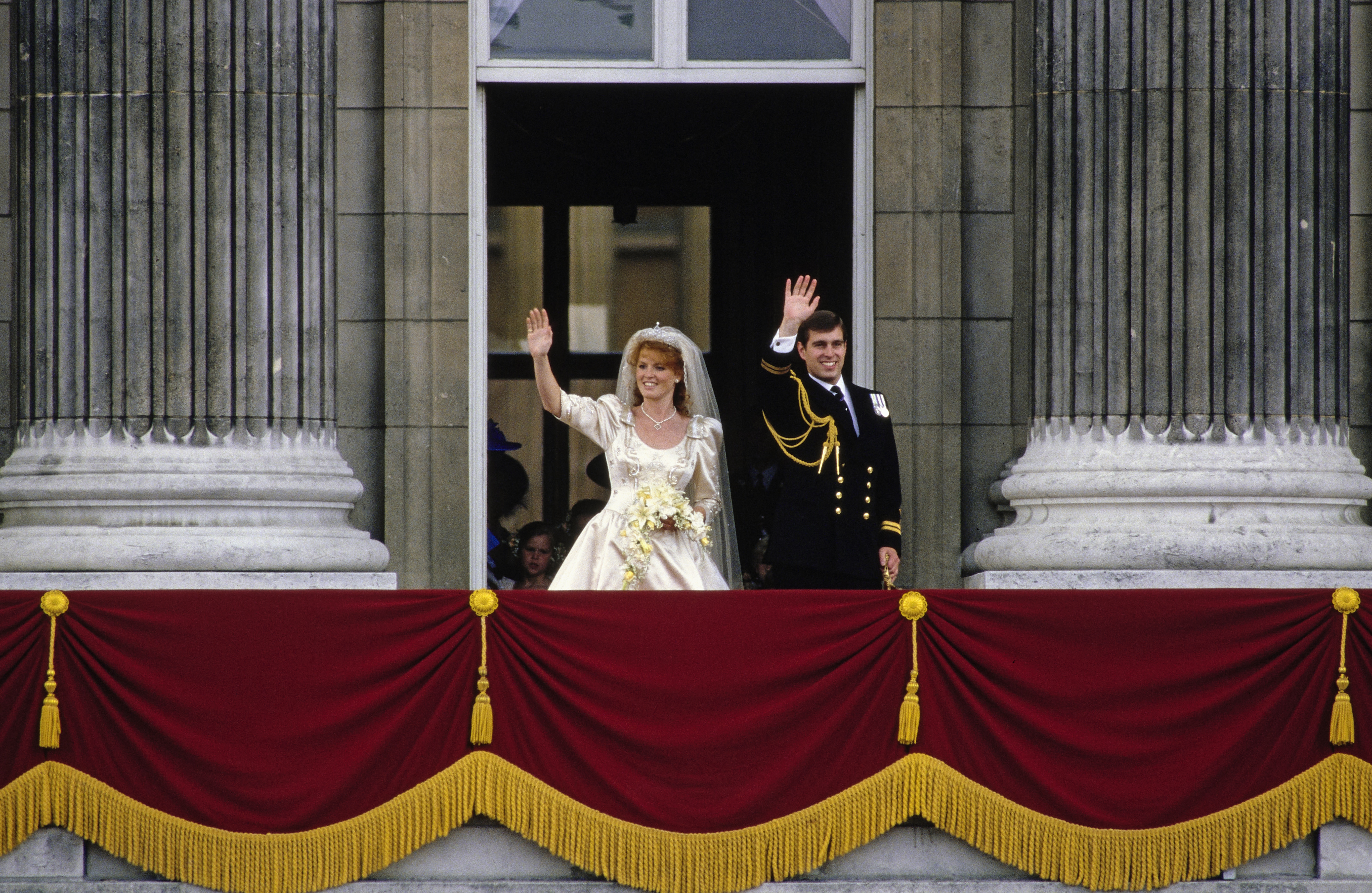 Sarah Ferguson and Prince Andrew waving from the Buckingham Palace balcony on their wedding day