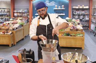 Daniel Jacobs, cooking in a large kitchen set, in 'Top Chef' episode 2103