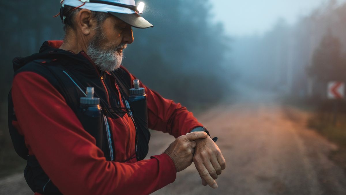 Trail runner checking GPS watch