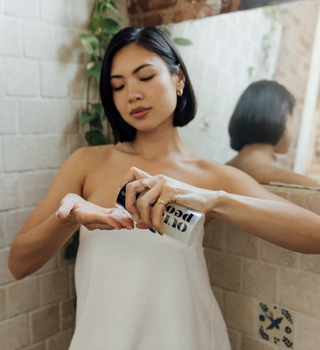 woman apply shaving cream in the bathroom