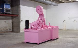 Pink art installation of a Geoge W. Bush look-alike committing buggery with a pig.