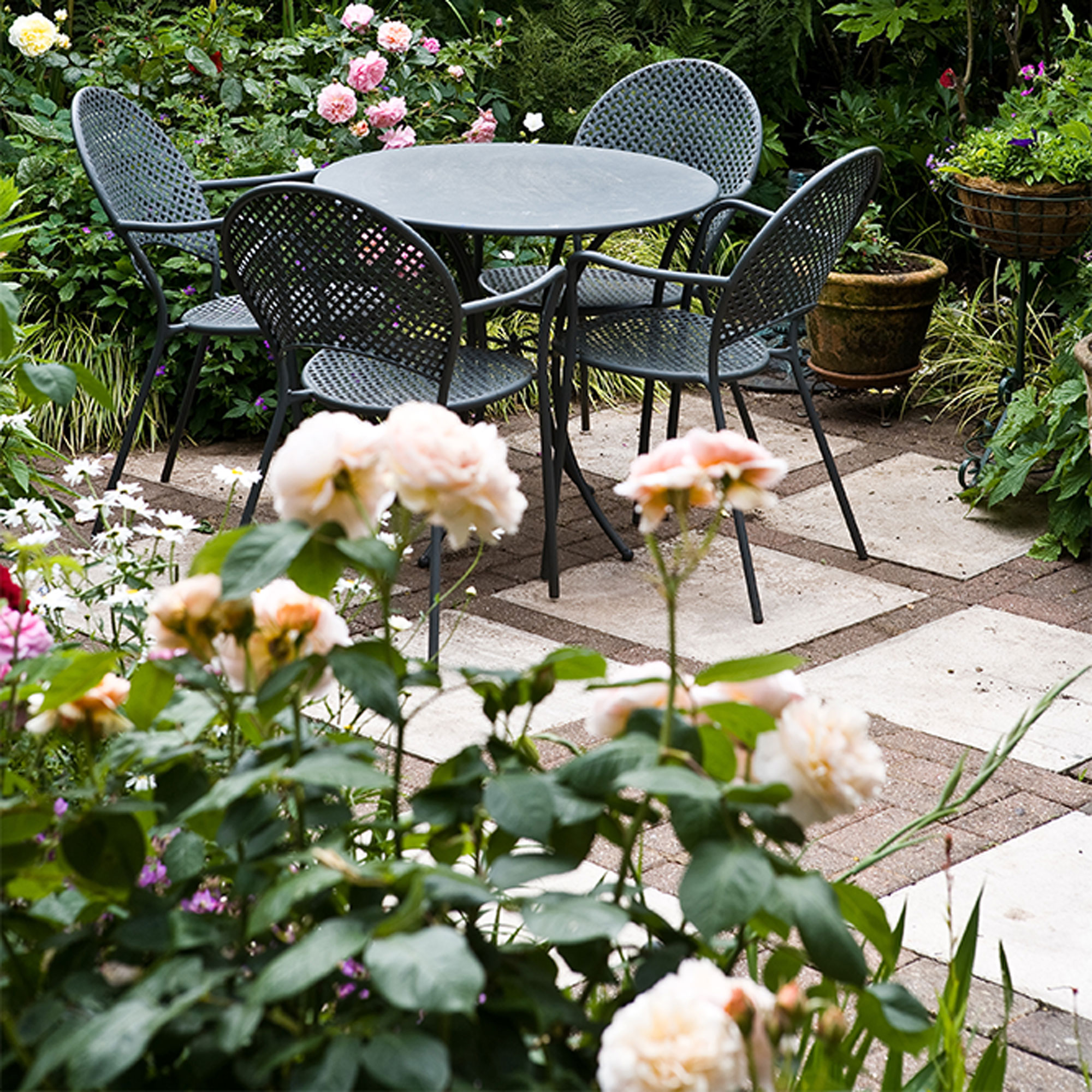 paving stone and brick garden path with dining table and chairs