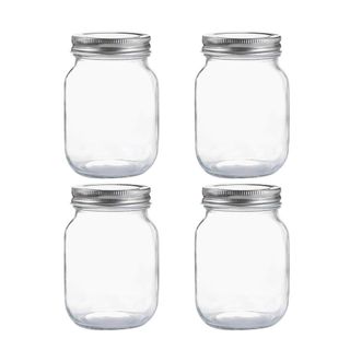 Four glass mason jars with silver lids