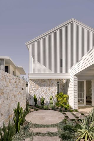the exterior of a home with white privacy slatting