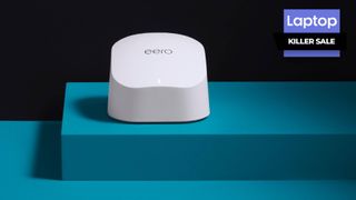 White Wi-Fi router sitting on teal platform