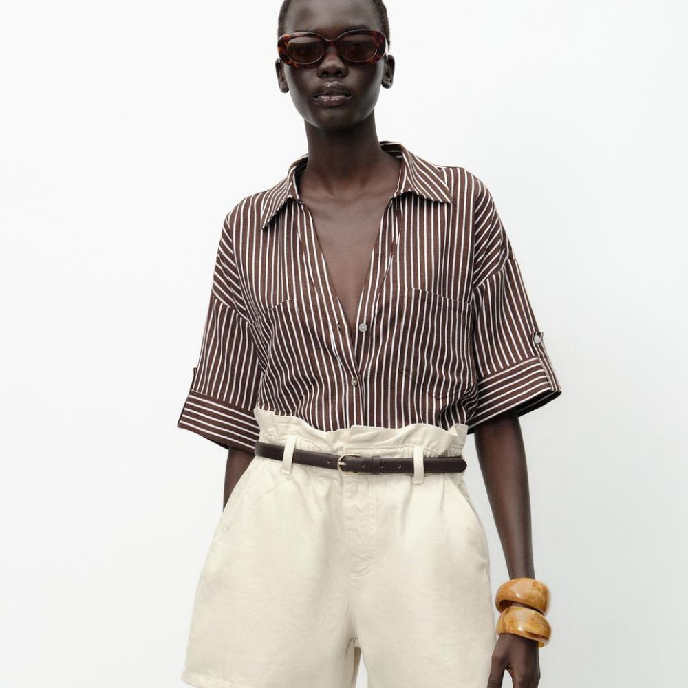 Woman wears striped shirt, paperbag shorts and chunky bangles