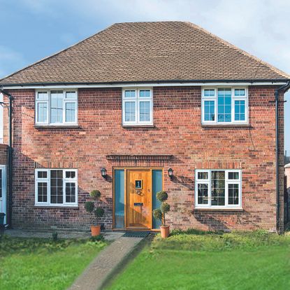 brick house exterior with white windows