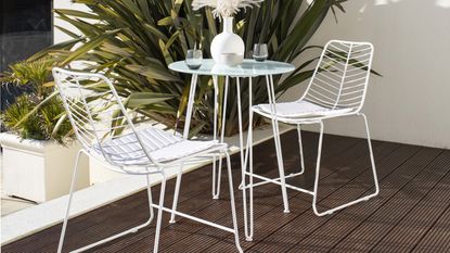 white metal bistro set from the Wayfair sale on a decked terrace