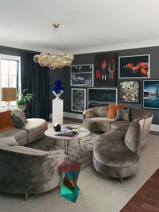 a living room with an oversized gallery wall and plinth