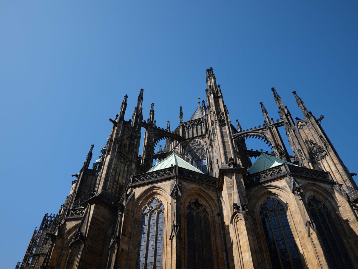 Church building in Prague with lots of spires in front of a blue sky