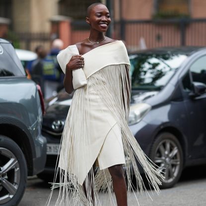 a woman wearing a fringe dress in street style
