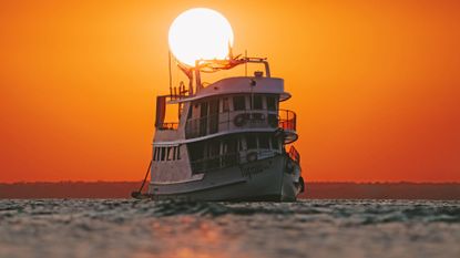 Sunset over the Tupaiú, a yacht with an “antique charm”