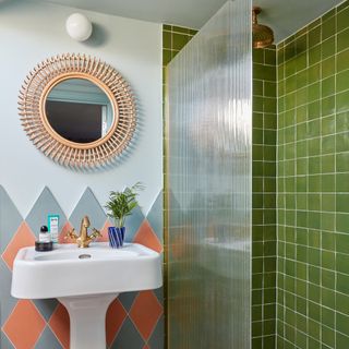 bathroom with green tiled walk-in shower and coral and grey tiled basin splashback